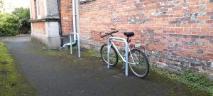 The side of Cores End Church where 2 bike stands are being modelled by Ann's old bicycle.